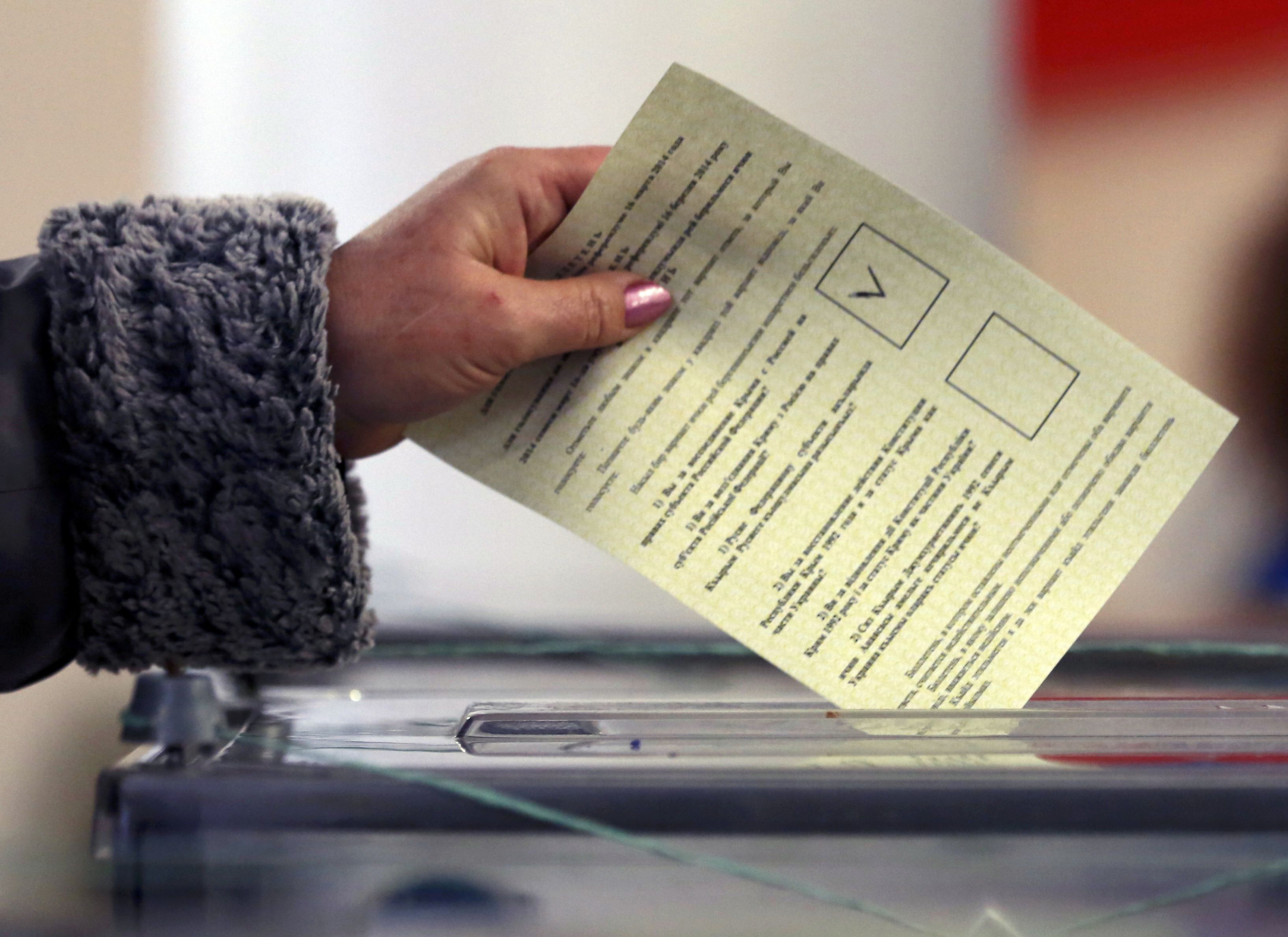 A woman casts her ballot during the referendum on the status of Ukraine's Crimea region at a polling station in Sevastopol